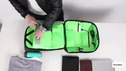 Interior of Kappa Alpha Psi Diamond backpack with bright green lining and multiple compartments. Organized storage for electronics, books, and accessories.